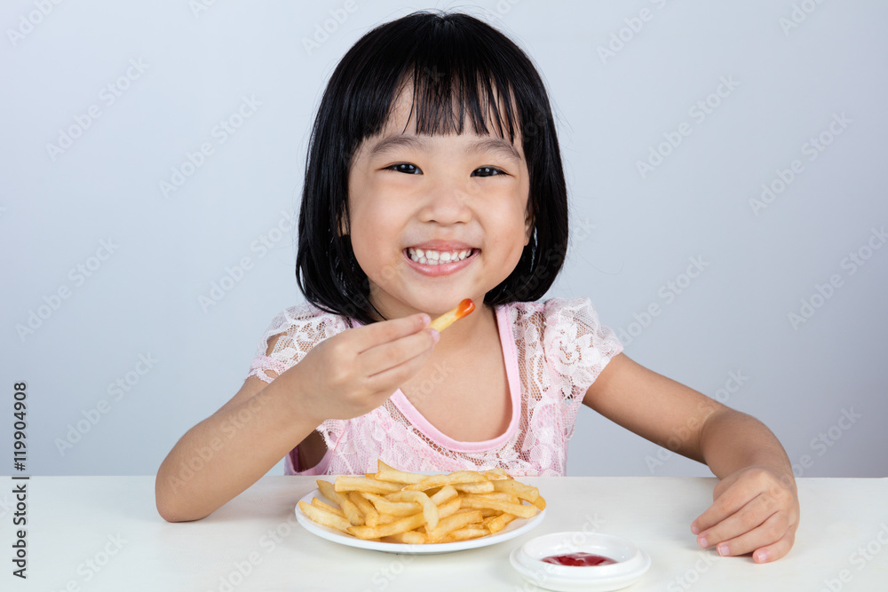 Happy Asian Chinese little girl Eating French Fries Happy Asian Chinese little girl Eating French Fries