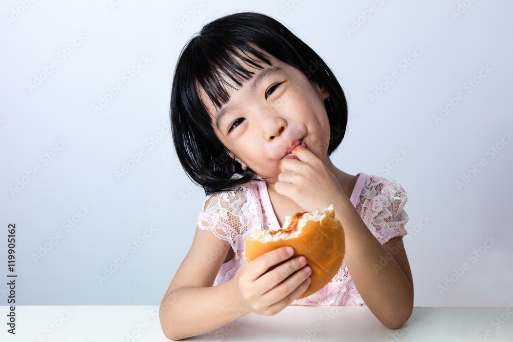 Happy Asian Chinese little girl Eating Burger Happy Asian Chinese little girl Eating Burger