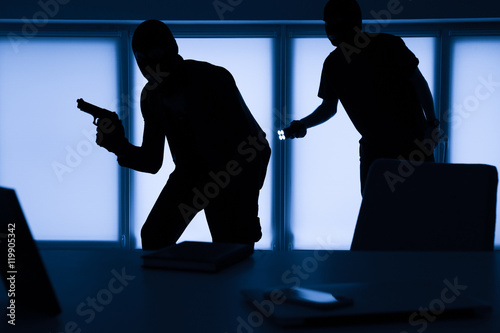 Fotografiet Armed thieves entering a house