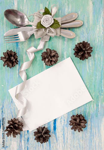Christmas dinner table setting with rustic decorations. Hanging decoration turquoise shabby table wooden Top view, flat lay with copyspace slogan text message. party invitation corporate event © yavdat