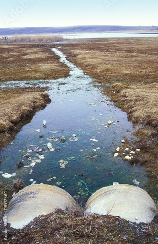 Sewage pipe coming above ground photo