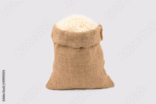 Jasmine rice in a  in small hemp sacks isolated on white background