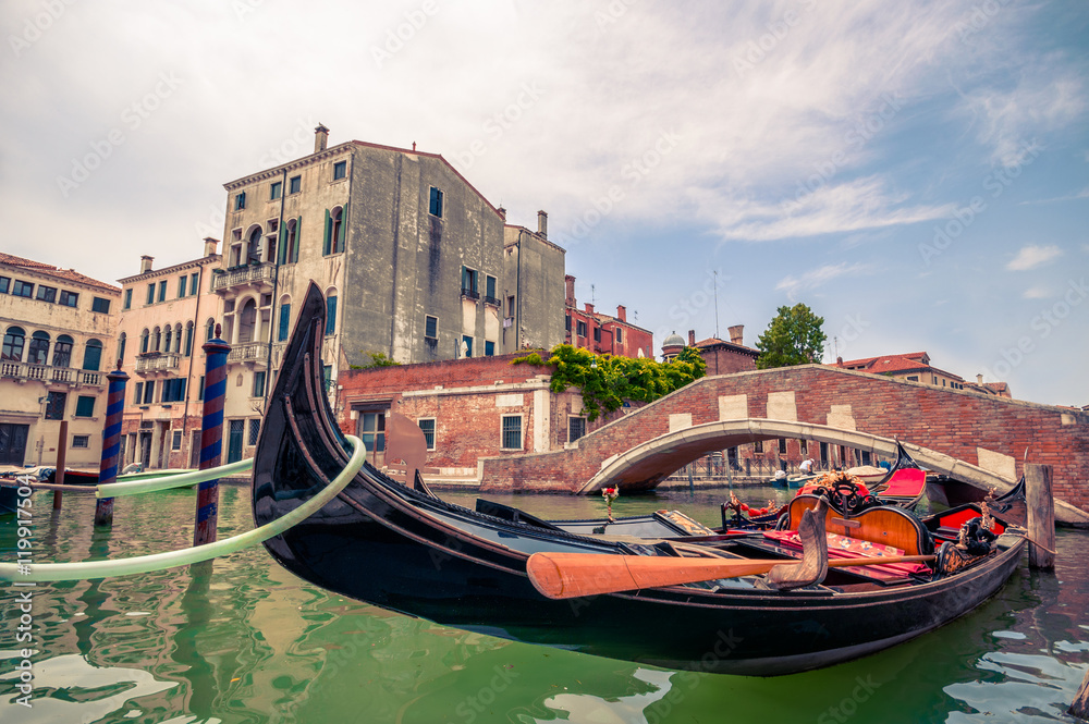 Beautiful scene with traditional gondola and canal in Venice, Italy