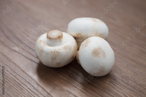 Champignon mushrooms on wooden table
