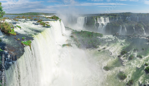 The Iguazu Falls with clouds and blue sky
