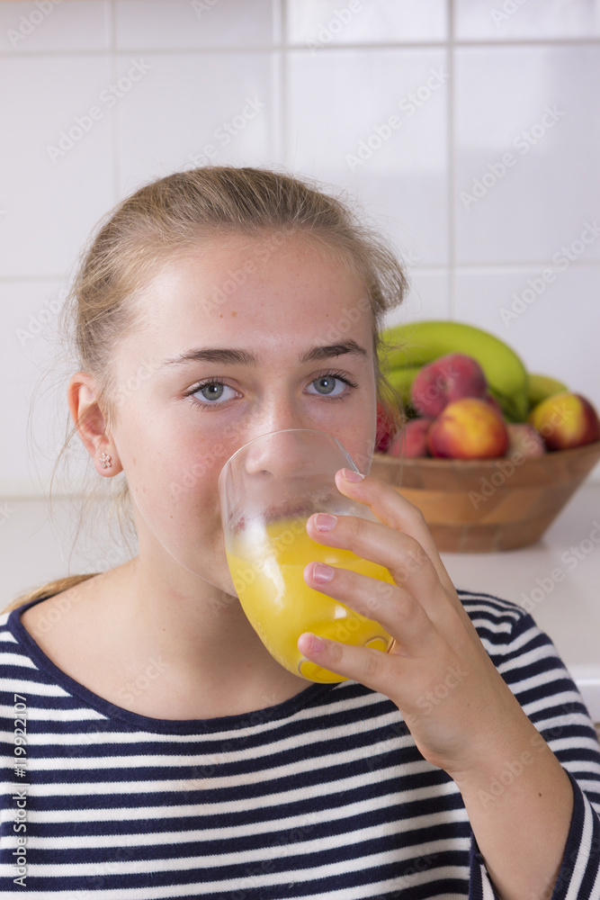 Girl with glass of juice in kitchen Girl with glass of juice in kitchen