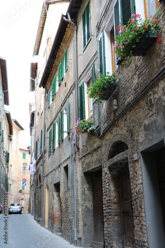 Old typical narrow alley in Siena, Tuscany Italy © ClaraNila