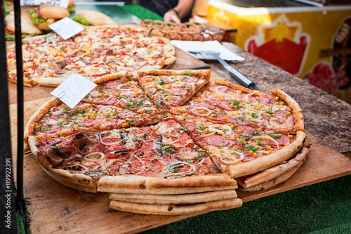 Fototapeta Naklejka Na Ścianę i Meble -  Closeup of pizza in street fast food cafe