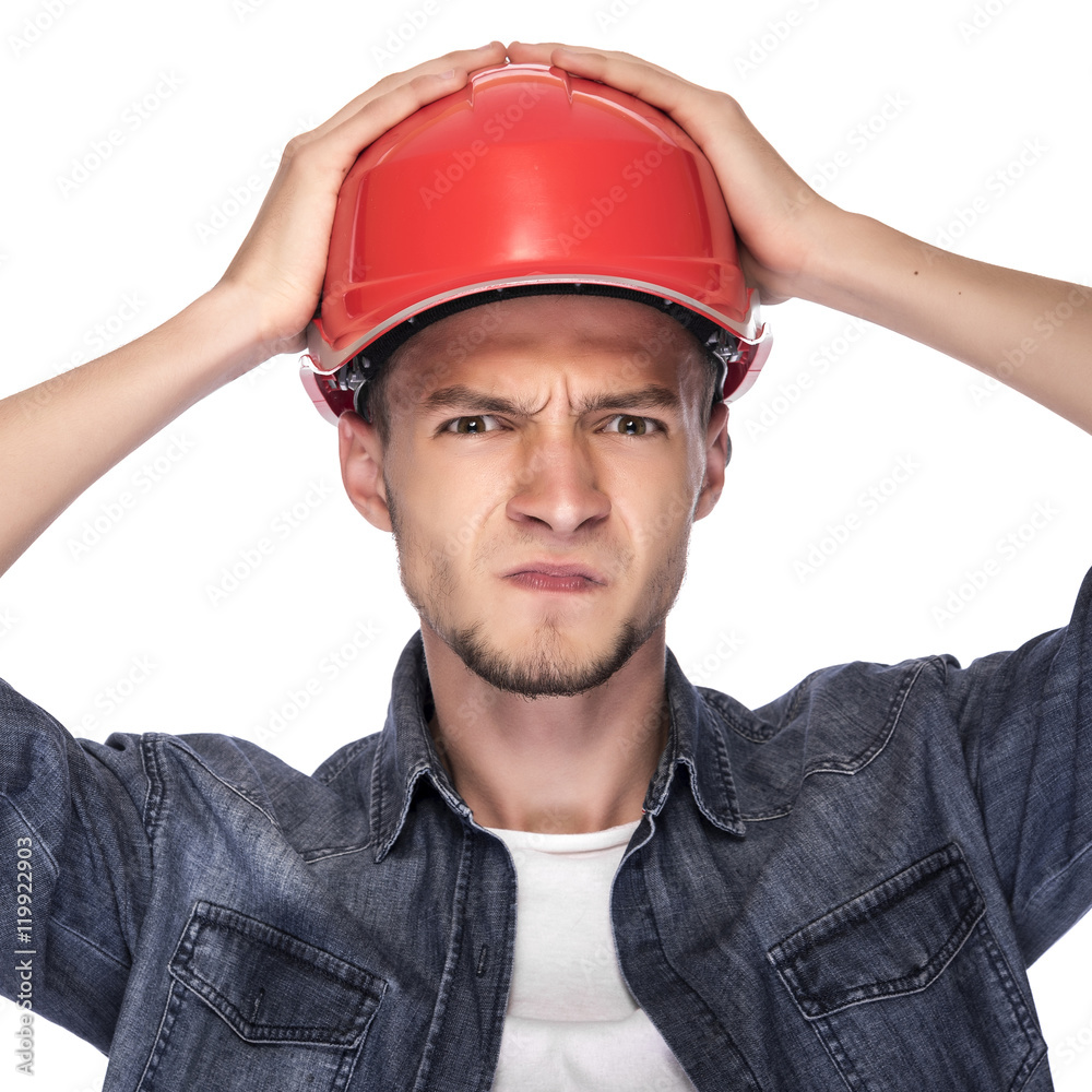 Young man in a construction helmet.
