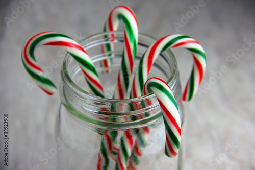 Candy Canes in a Glass Jar Set On a White Background