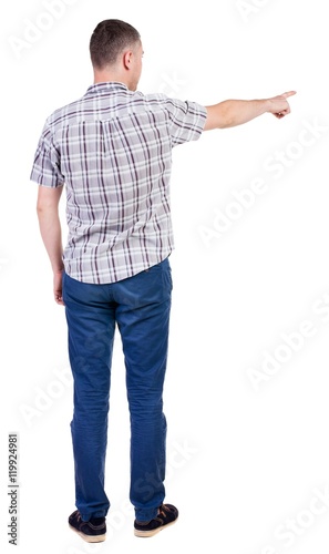 Back view of  pointing young men in  shirt and jeans. Young guy  gesture. Rear view people collection.  backside view of person.  Isolated over white background.  © ghoststone