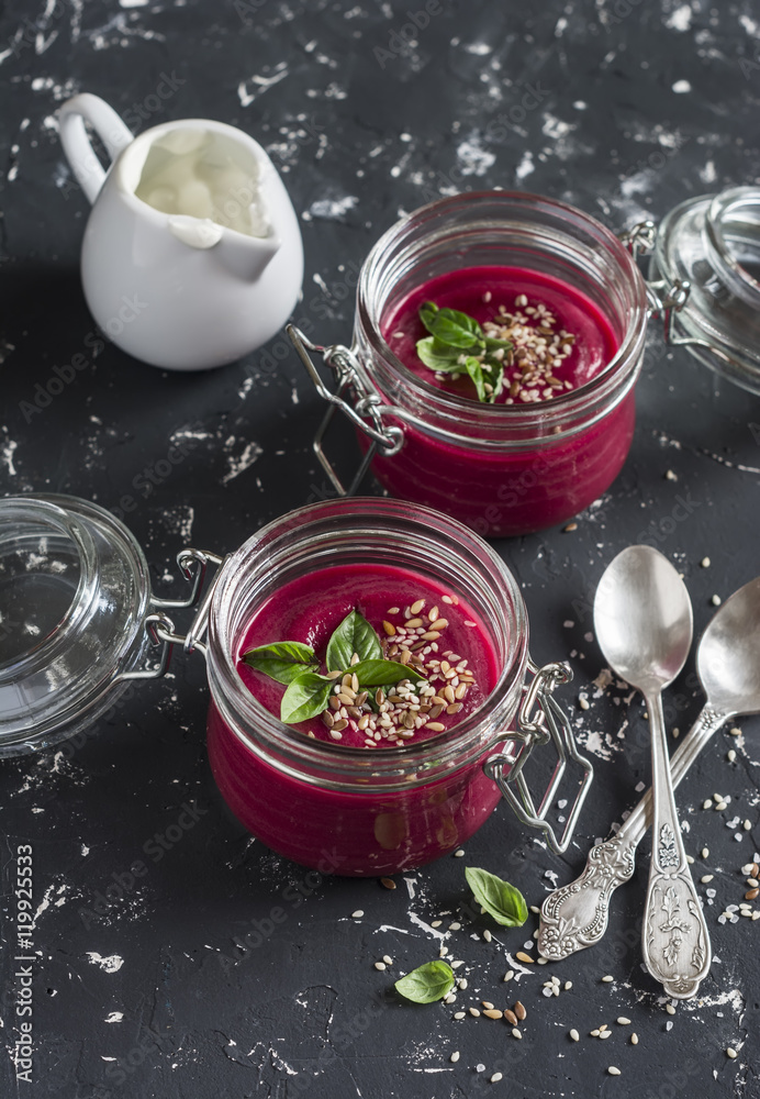 Beet soup in glass jars on a dark background. Healthy vegetarian food. Beet soup in glass jars on a dark background. Healthy vegetarian food.