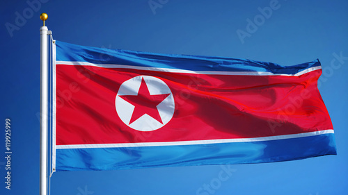 North Korea flag waving against clean blue sky, close up, isolated with clipping path mask alpha channel transparency