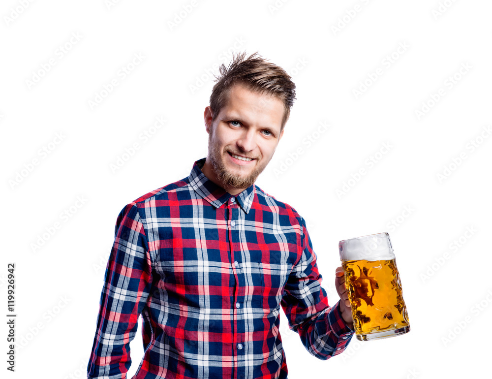 Hipster man in checked shirt holding beer, studio shot Hipster man in checked shirt holding beer, studio shot