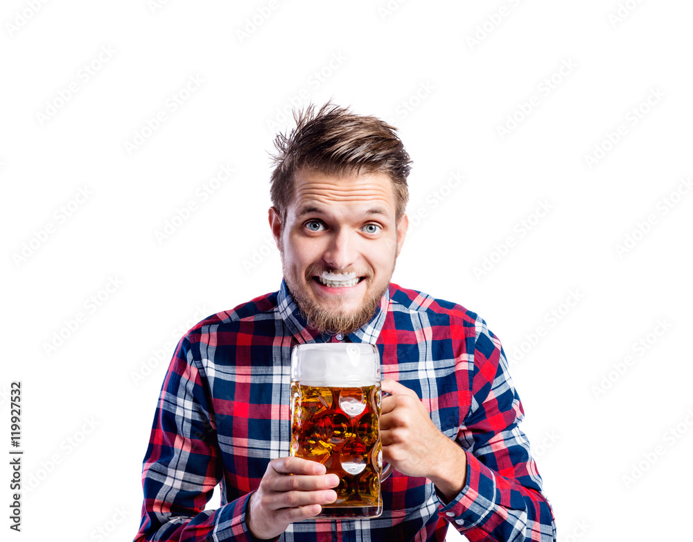 Hipster man in checked shirt drinking beer, studio shot Hipster man in checked shirt drinking beer, studio shot
