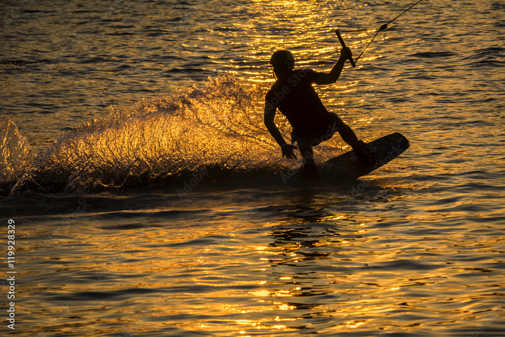 Silhouette Wakeboarder in action on sunset