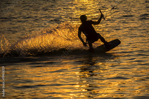 Silhouette Wakeboarder in action on sunset