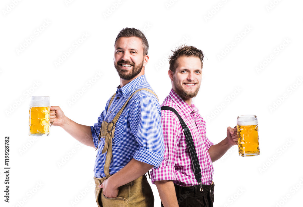 Men in traditional bavarian clothes holding mugs of beer Men in traditional bavarian clothes holding mugs of beer