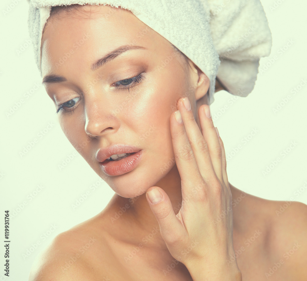 Portrait of beautiful girl touching her face with a towel on head Portrait of beautiful girl touching her face with a towel on head