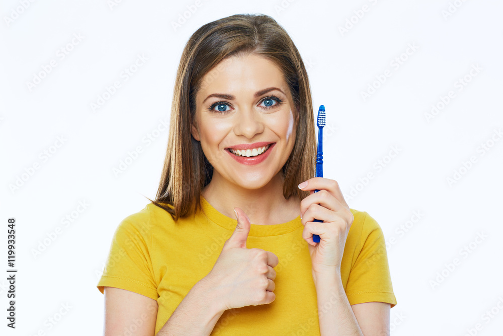 Smiling woman with healthy teeth holding toothy brush show thumb Smiling woman with healthy teeth holding toothy brush show thumb
