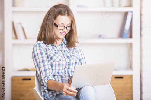 Free Download Smiling woman using laptop - GFXLoad