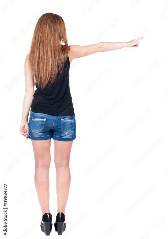 Back view of pointing woman. beautiful redhead girl in shorts. Rear view people collection. backside view of person. Isolated over white background. Back view of pointing woman. beautiful redhead girl in shorts. Rear view people collection. backside view of person. Isolated over white background.