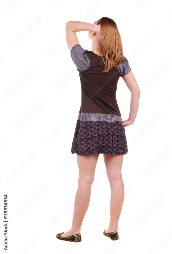 Beautiful young woman looking at wall. Rear view. Isolated over white. Beautiful young woman looking at wall. Rear view. Isolated over white.