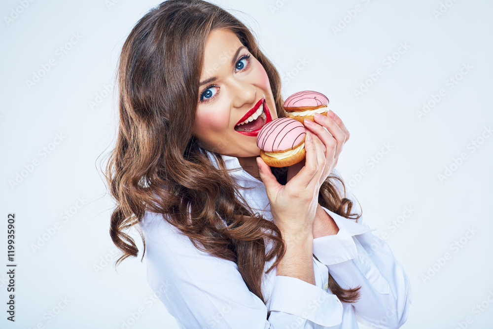 Young woman bites cake. Close up portrait of beautiful woman