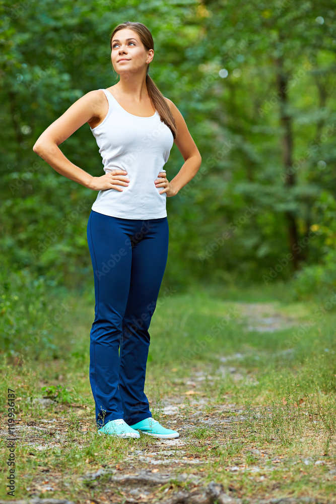 Young active style woman full body portrait in forest. Young active style woman full body portrait in forest.