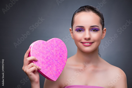Woman with present in heart shaped box