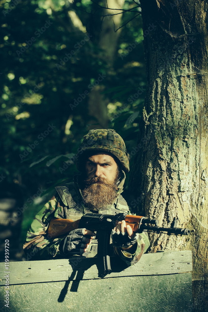 Fototapeta premium Young soldier with gun