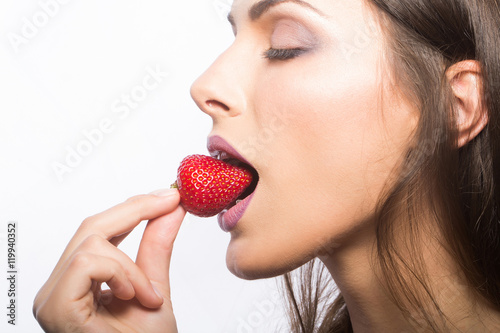 sexy woman eating red strawberry