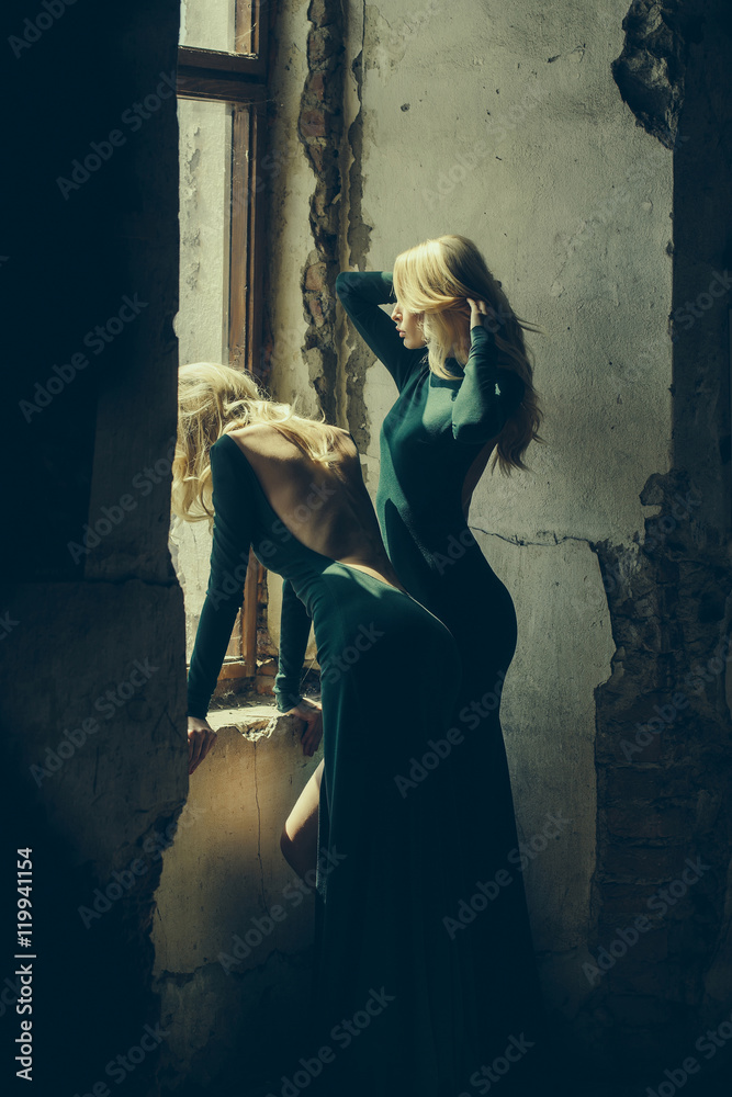 pretty women in green dresses near window pretty women in green dresses near window