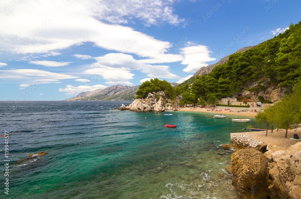 Naklejka premium small intimate rocky beach and beautiful blue sea