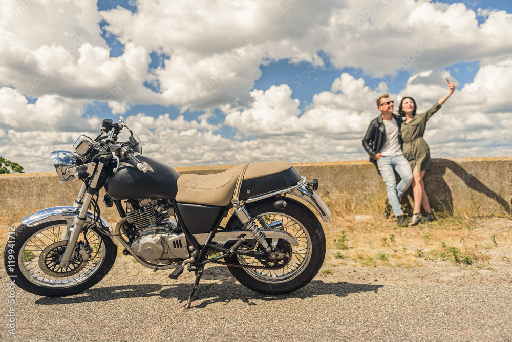 Young couple traveling by motorcycle