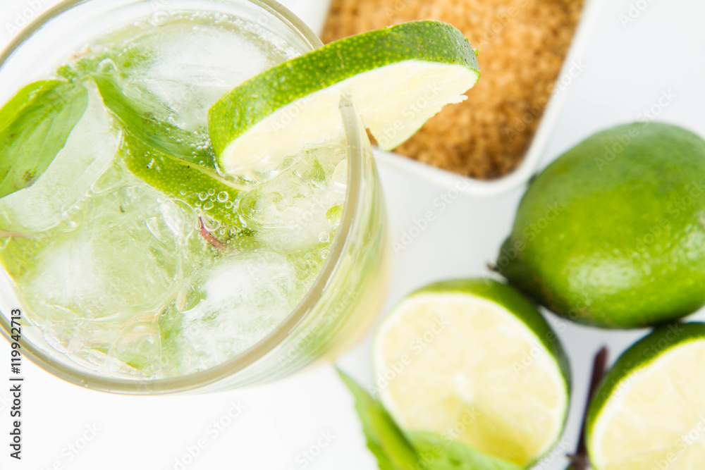 Mojito in a glass and ingredients on a white background Mojito in a glass and ingredients on a white background