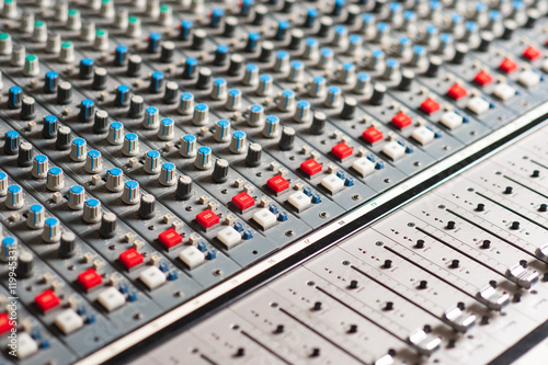 Large audio sound mixer with buttons and knobs.