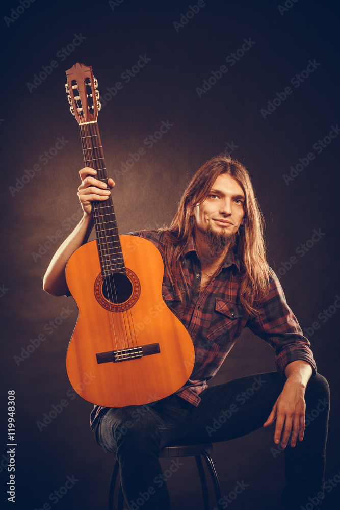 Guitarist is posing with guitar. Guitarist is posing with guitar.