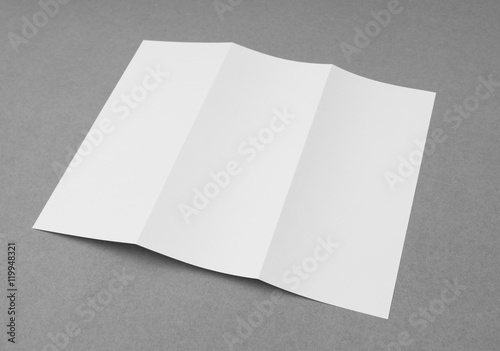 Trifold white template paper on gray background . © jannoon028