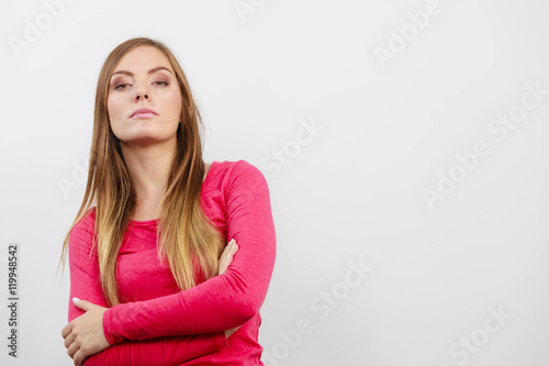 Young woman holding arms crossed.