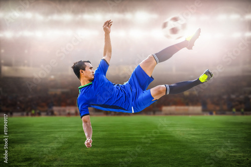 closeup of soccer striker shooting ball in the stadium