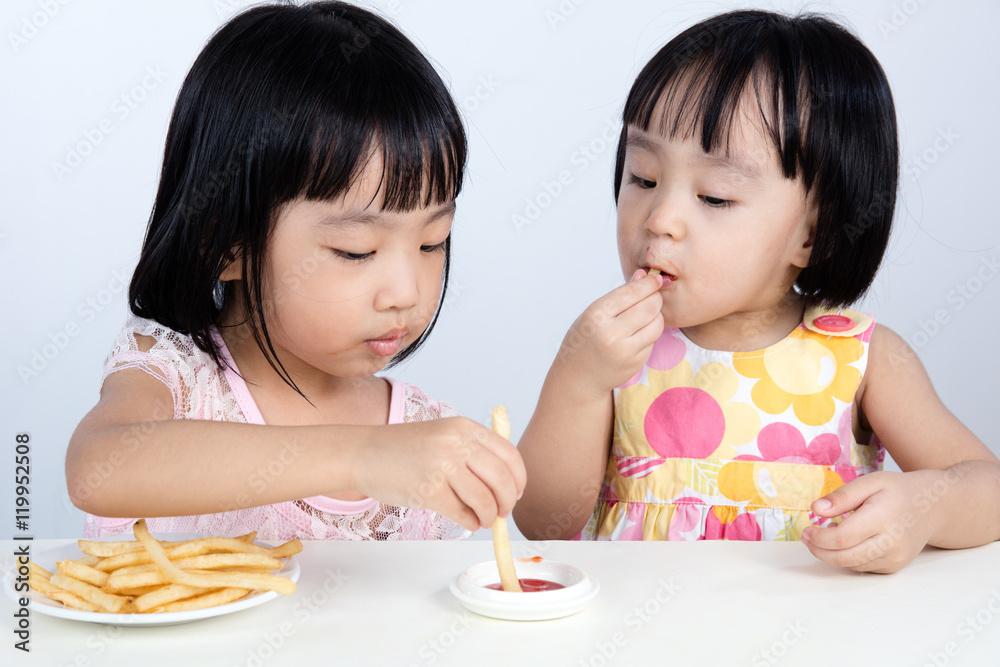 Asian Chinese little girl Eating French fries Asian Chinese little girl Eating French fries