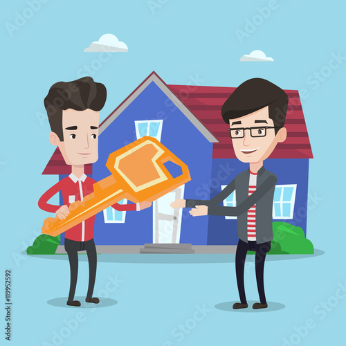 Real estate agent giving key to new house owner.
