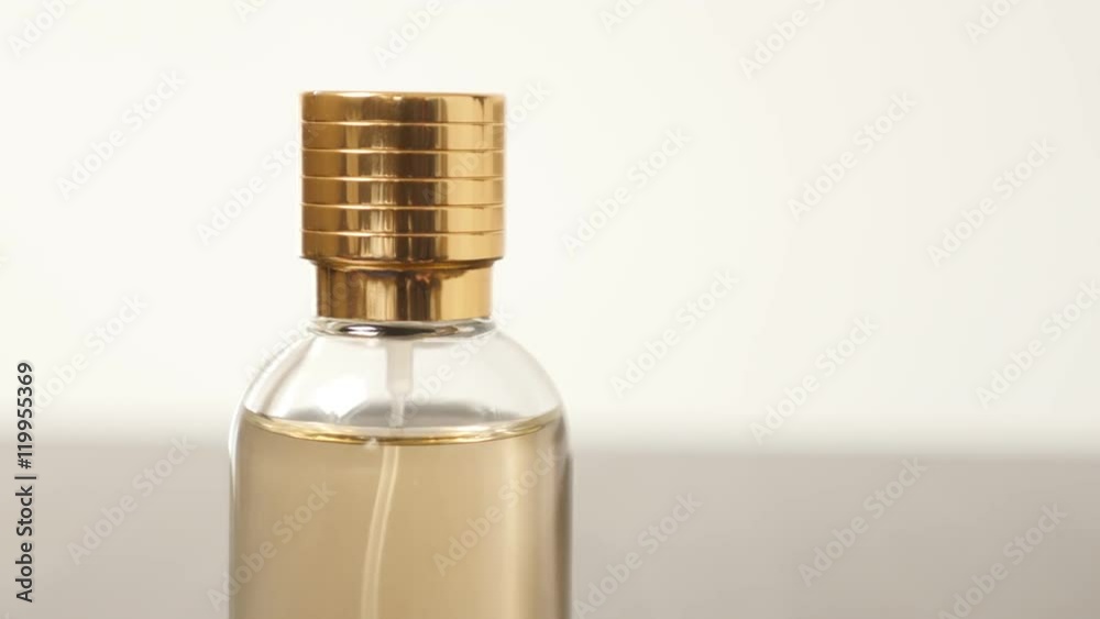 Golden fragrance color in golden cap bottle slow tilt 4K 2160p 30fps UltraHD footage - Perfume bottle on wooden surface close-up 4K 3840X2160 UHD tilting video Golden fragrance color in golden cap bottle slow tilt 4K 2160p 30fps UltraHD footage - Perfume bottle on wooden surface close-up 4K 3840X2160 UHD tilting video