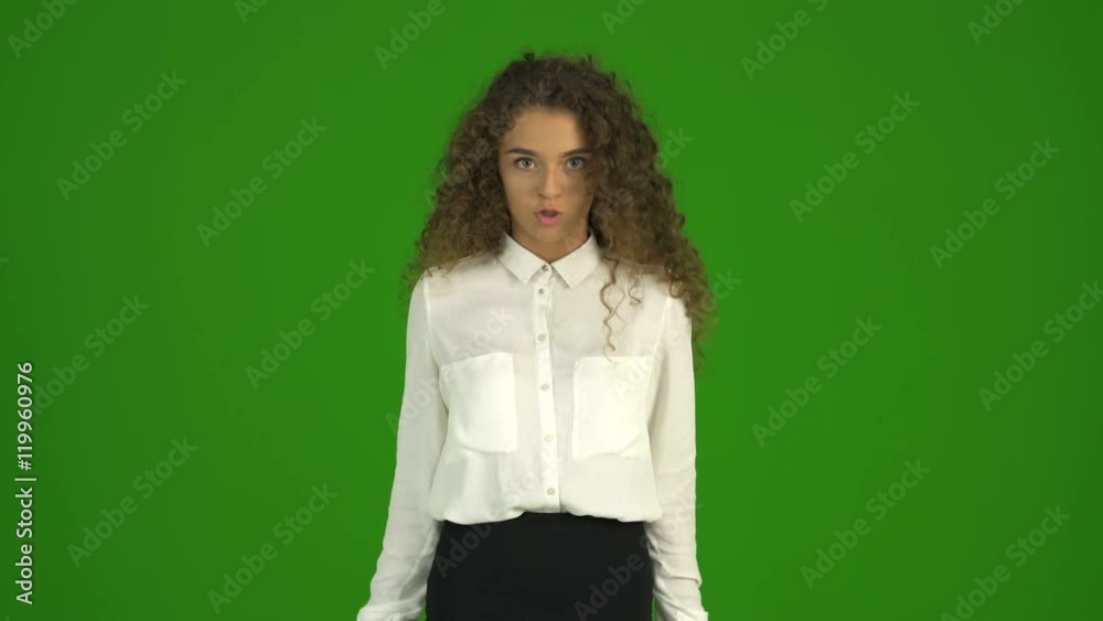 The curly businesswoman talk with emotion on the green background. Real time The curly businesswoman talk with emotion on the green background. Real time