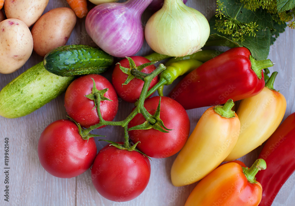 Close up of various colorful fresh raw vegetables. Flat lay. On black wooden table. Close up of various colorful fresh raw vegetables. Flat lay. On black wooden table.