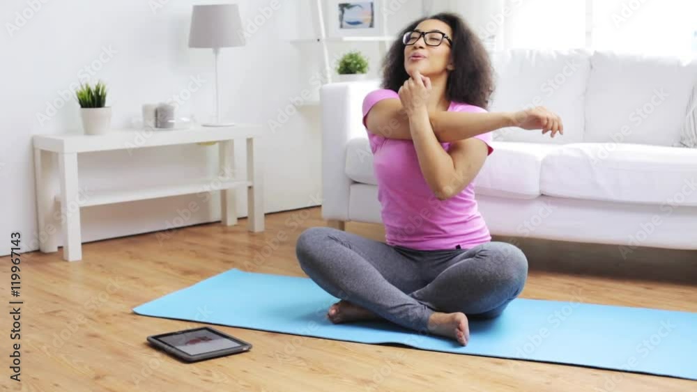 happy african woman exercising on mat at home happy african woman exercising on mat at home