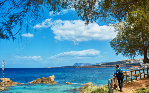 Obraz na plátně woman tourist walking on the waterfront of Chania bay backround, Crete, Greece
