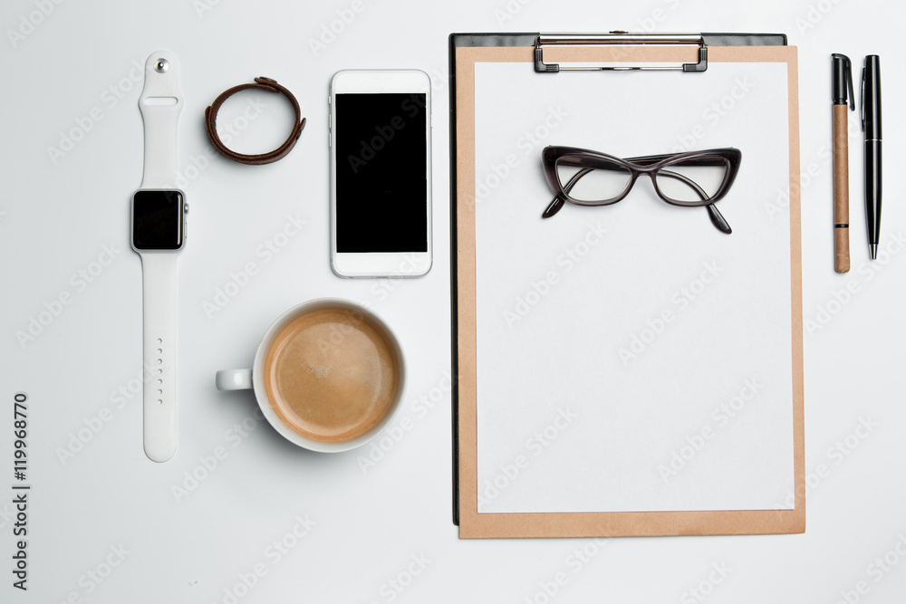 Office desk table with cup, supplies, phone on white Office desk table with cup, supplies, phone on white