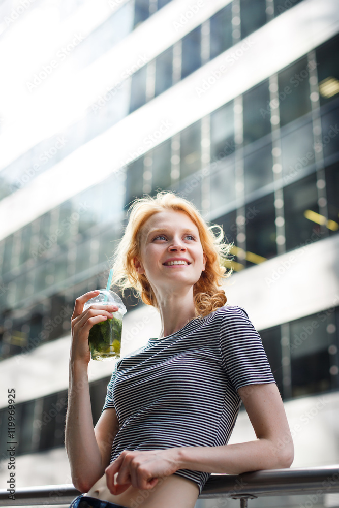 Portrait on urban background of slim hipster girl with mojito Portrait on urban background of slim hipster girl with mojito